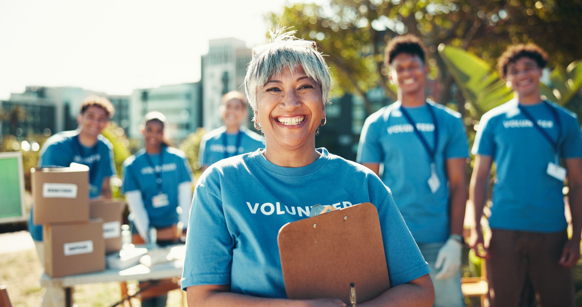 Activism, portrait and smile of woman volunteer outdoor in park for community food drive or donation. Charity, help and society with happy mature person as welfare worker for NGO or non profit